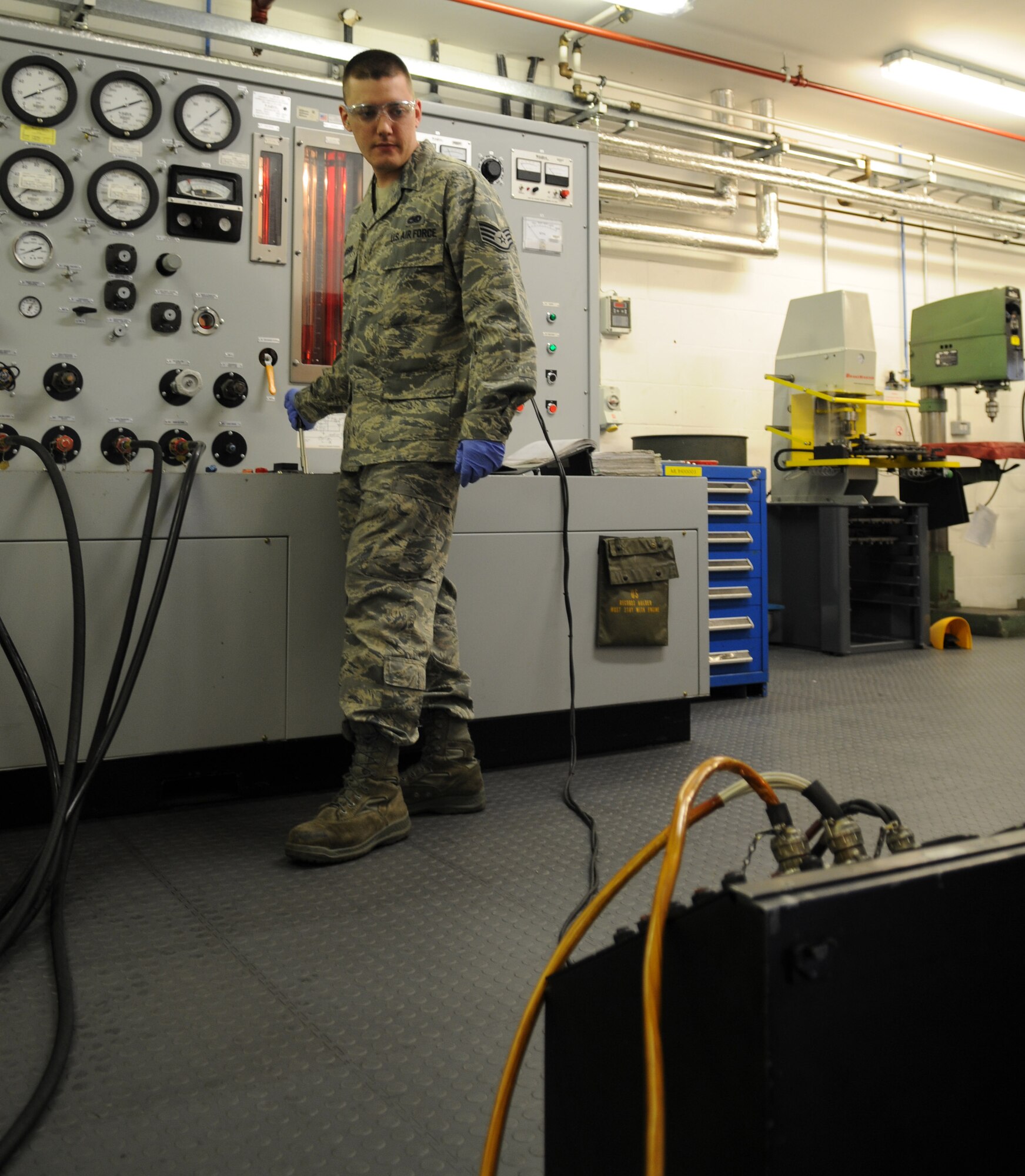 RAF MILDENHALL, England – Staff Sgt. Casey Jackson, 100th Maintenance Squadron aircraft hydraulics journeyman, adjusts a lever on the hydraulic test stand while monitoring a gauge on the air refueling boom tester June 12, 2012 in the hydraulics shop here. As parts are adjusted, the ARBT, a replica of the boomer panel on board a KC-135 Stratotanker, reflects the change. (U.S. Air Force photo/Senior Airman Rachel Waller)