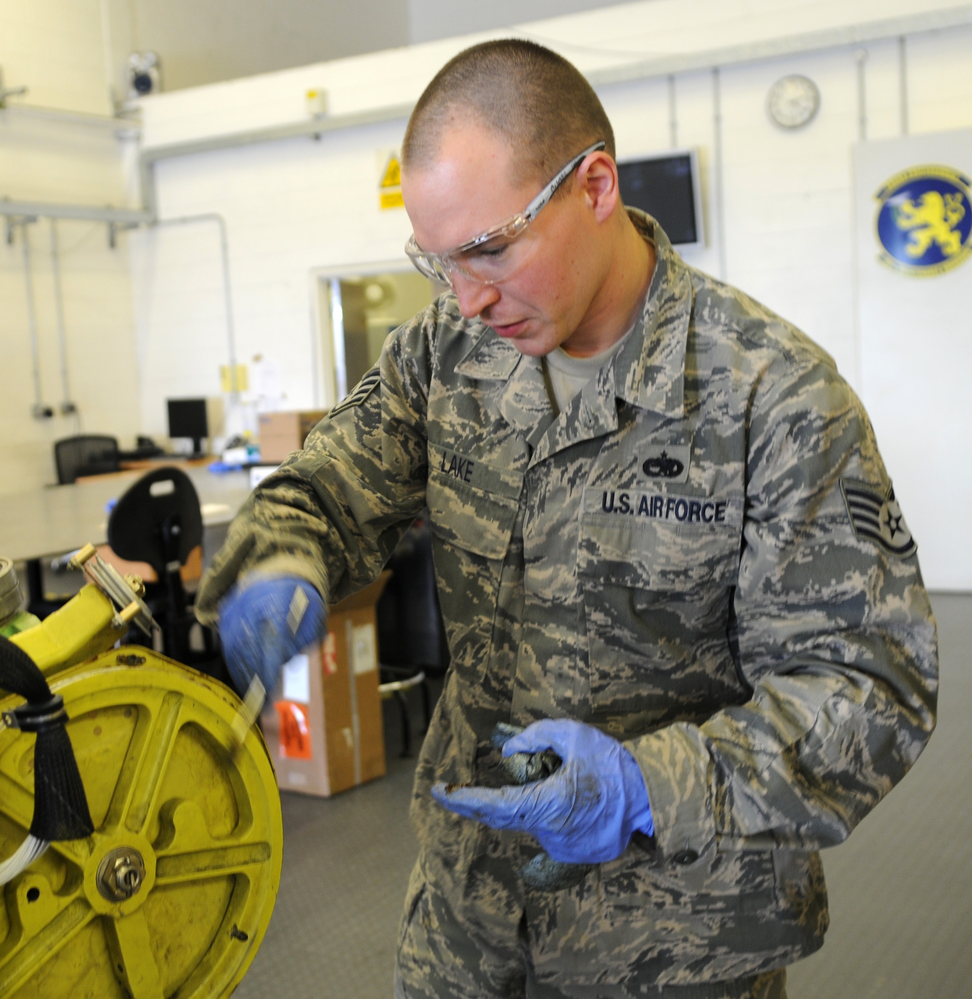 RAF MILDENHALL, England – Staff Sgt. Marcus Lake, 100th Maintenance Squadron aircraft hydraulics journeyman, applies grease to ruddervator cables on a KC-135 Stratotanker boom June 12, 2012, in the hydraulics shop here. The ruddervator cable is greased before re-paneling the boom to keep the cables from corroding. (U.S. Air Force photo/Senior Airman Rachel Waller)