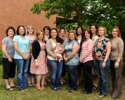 MINOT AIR FORCE BASE, N.D. -- Members of the Minot Officers’ Spouses’ Club 2010 to 2012 boards pose outside of the base library here. Members of the MOSC are very involved within the Team Minot Community; just over the past year and a half they have donated more than $14,000 to various base and local organizations. (U.S. Air Force photo/Airman 1st Class Stephanie Ashley)

