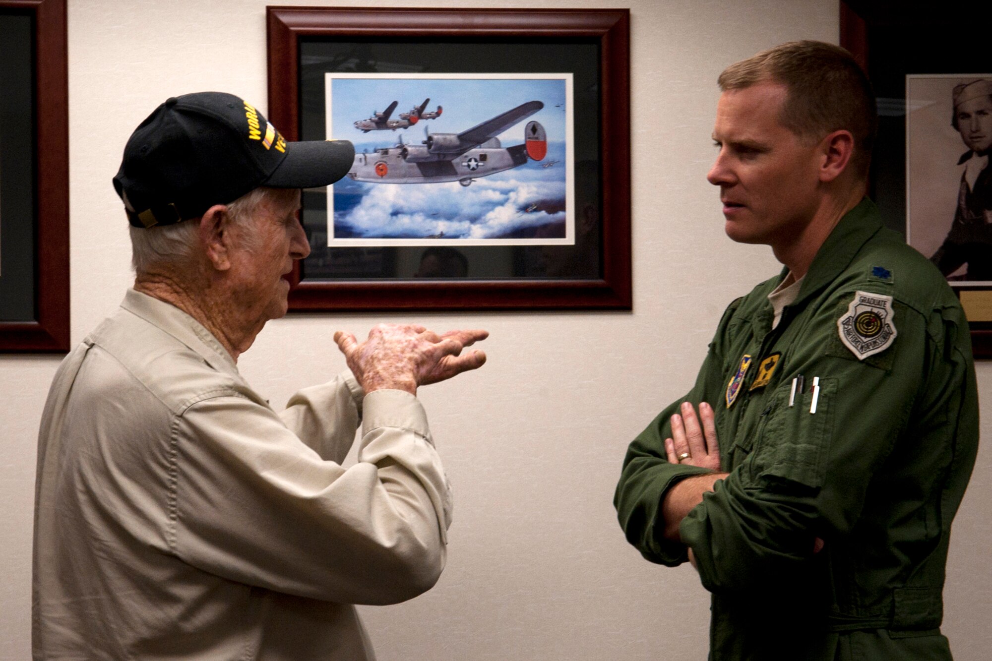 Claude McCrocklin talks to U.S. Air Force Lt. Col. Heath Wharton, 11th Bomb Squadron commander, about his time as a bombardier on B-24 Liberators, Barksdale Air Force Base, La., June 1, 2012. The 11th BS dedicated a conference in honor of McCrocklin for his service and sacrifice during World War II. (U.S. Air Force photo by Master Sgt. Greg Steele/Released)