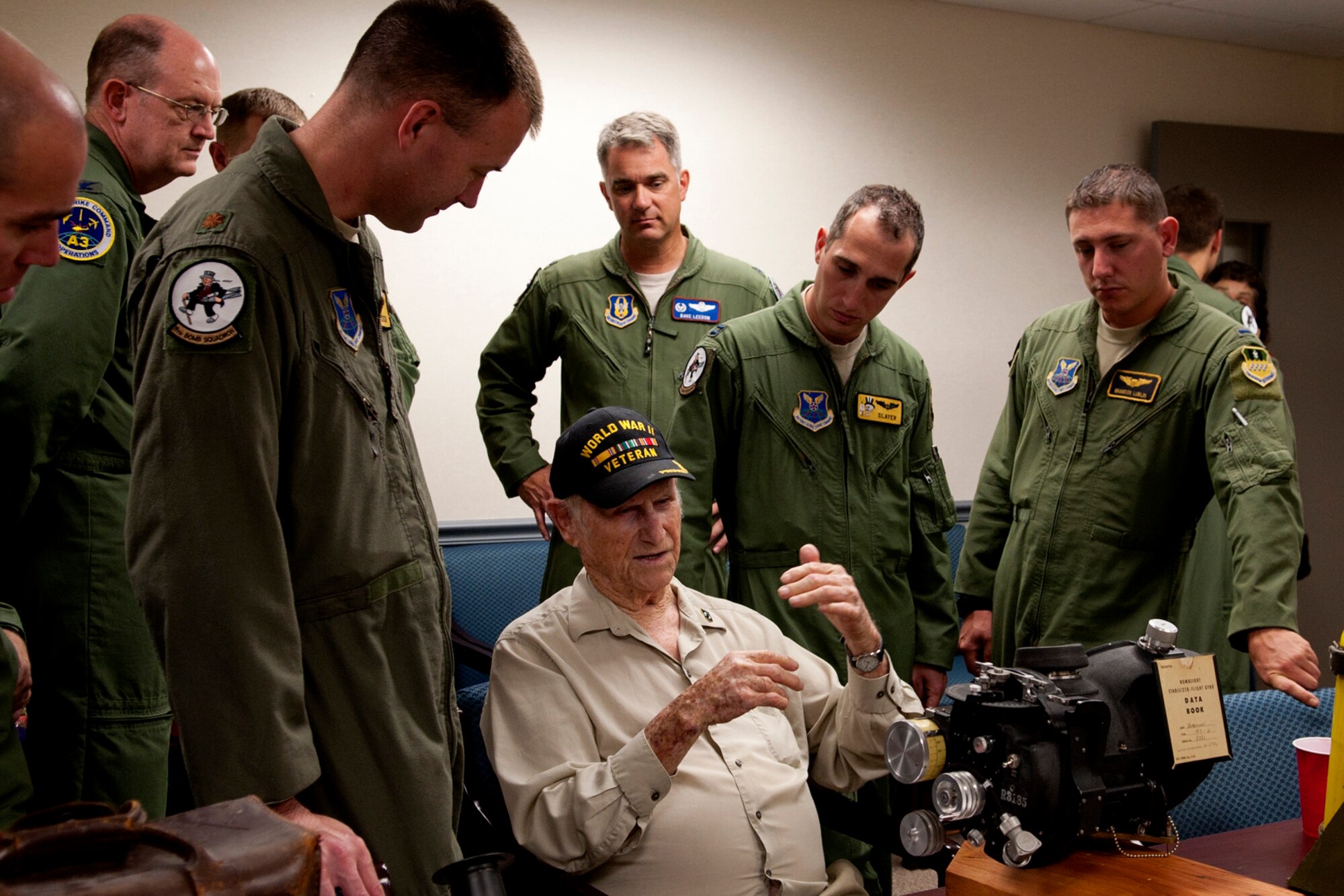 Airmen from the 11th and 93rd Bomb Squadrons look on as Claude McCrocklin talks about bombing tactics during World War II, Barksdale Air Force Base, La., June 1, 2012. McCrocklin, who lost a cousin on the U.S.S. Arizona during the Japanese attack on Pearl Harbor, enlisted into the Army Air Corps, becoming a bombardier on the B-24 Liberator. (U.S. Air Force photo by Master Sgt. Greg Steele/Released)