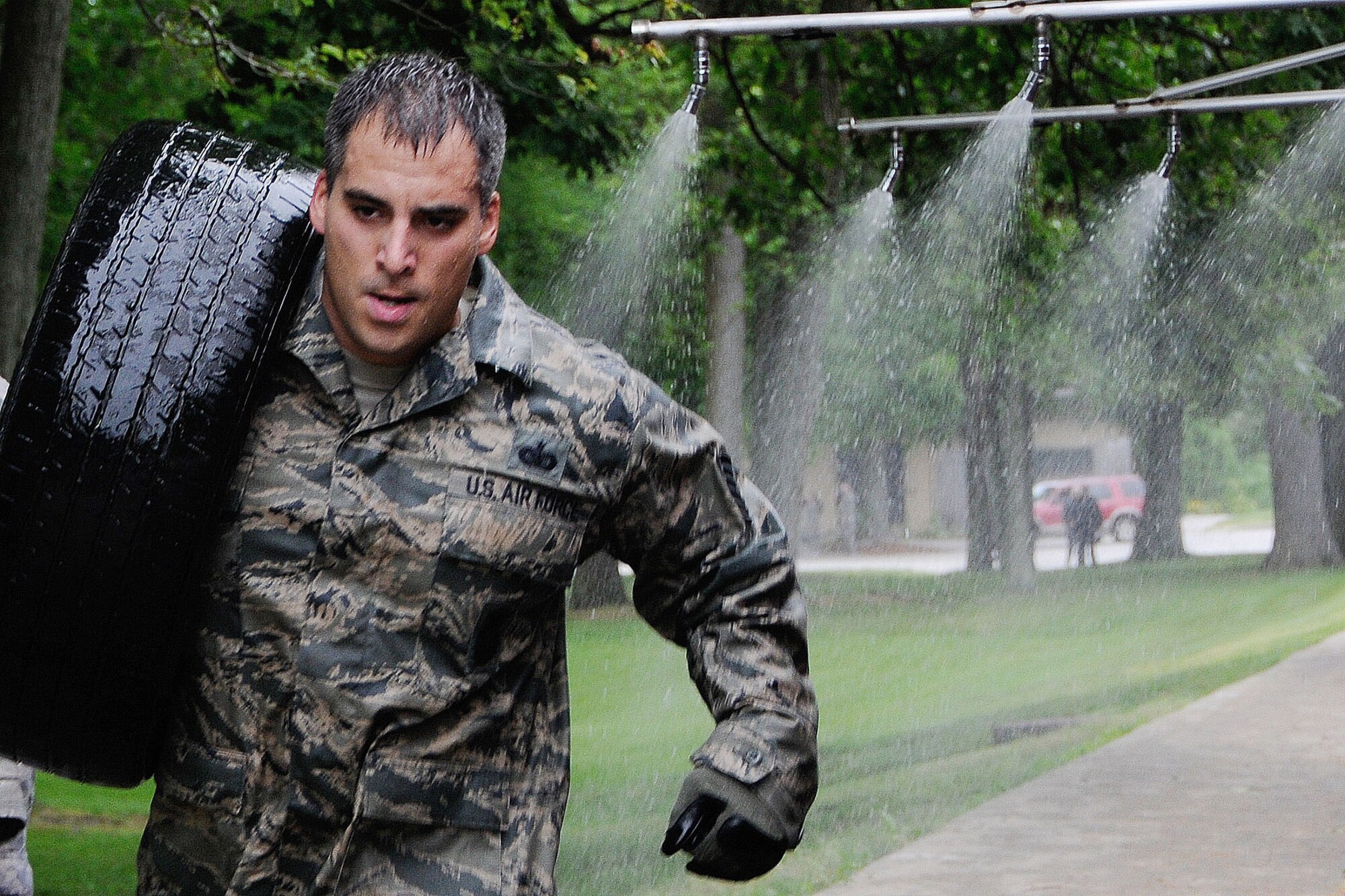 HANSCOM AIR FORCE BASE, Mass. – Tech. Sgt. Don V. San Juan, from the 66th Security Forces Squadron, carries a tire during one of the physical training events as part of the 66th Air Base Group Warrior Day June 5. The group plans to hold Warrior Day once a month. (U.S. Air Force photo by Linda LaBonte Britt)