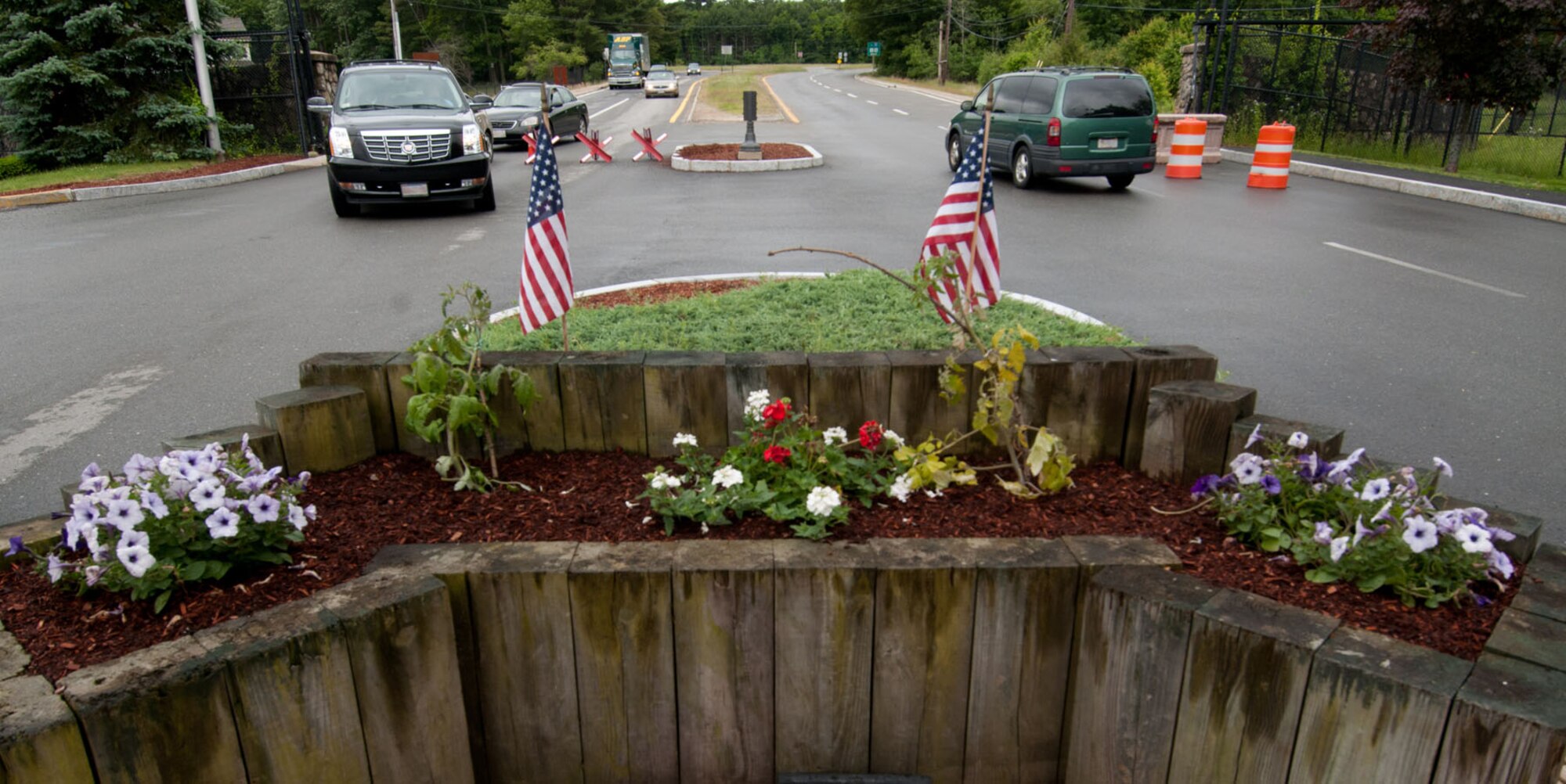 HANSCOM AIR FORCE BASE, Mass. – Motorists prepare to drive by freshly planted flowers at the Vandenberg Gate June 5. The flowers were purchased by the Hanscom Spouses Club for the 66th Air Base Group change of command ceremony and former installation commander Col. Stacy L. Yike’s retirement dinner, but repurposed by HSC member Marlene Peeler for a base beautification project. (U.S. Air Force photo by Rick Berry)