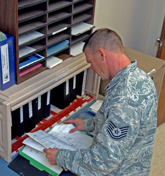 Tech. Sgt. Jeffrey Baker, 2nd Maintenance Group quality assurance inspector, reviews a technical order at the 2nd Maintenance Squadron Accessories Flight Electrical and Environmental shop at Barksdale Air Force Base, La., June 11. Baker conducts monthly inspections at 64 different sections that can cover TOs, tools, housekeeping and personnel evaluations. (U.S. Air Force photo/Staff Sgt. Jason McCasland)(RELEASED)