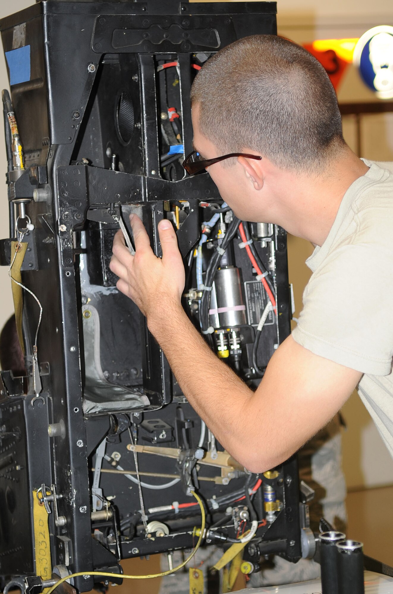 U.S. Air Force Airman Jacob Hatcher inspects the inside of an F-15E Strike Eagle ejection seat on Seymour Johnson Air Force Base, N.C., June 12, 2012. It takes approximately four days to perform maintenance and inspect the ejection seat before it is reinstalled in the aircraft. Hatcher, 4th Component Maintenance Squadron egress apprentice, hails from Clover, S.C. (U.S. Air Force photo/Senior Airman Gino Reyes/Released)