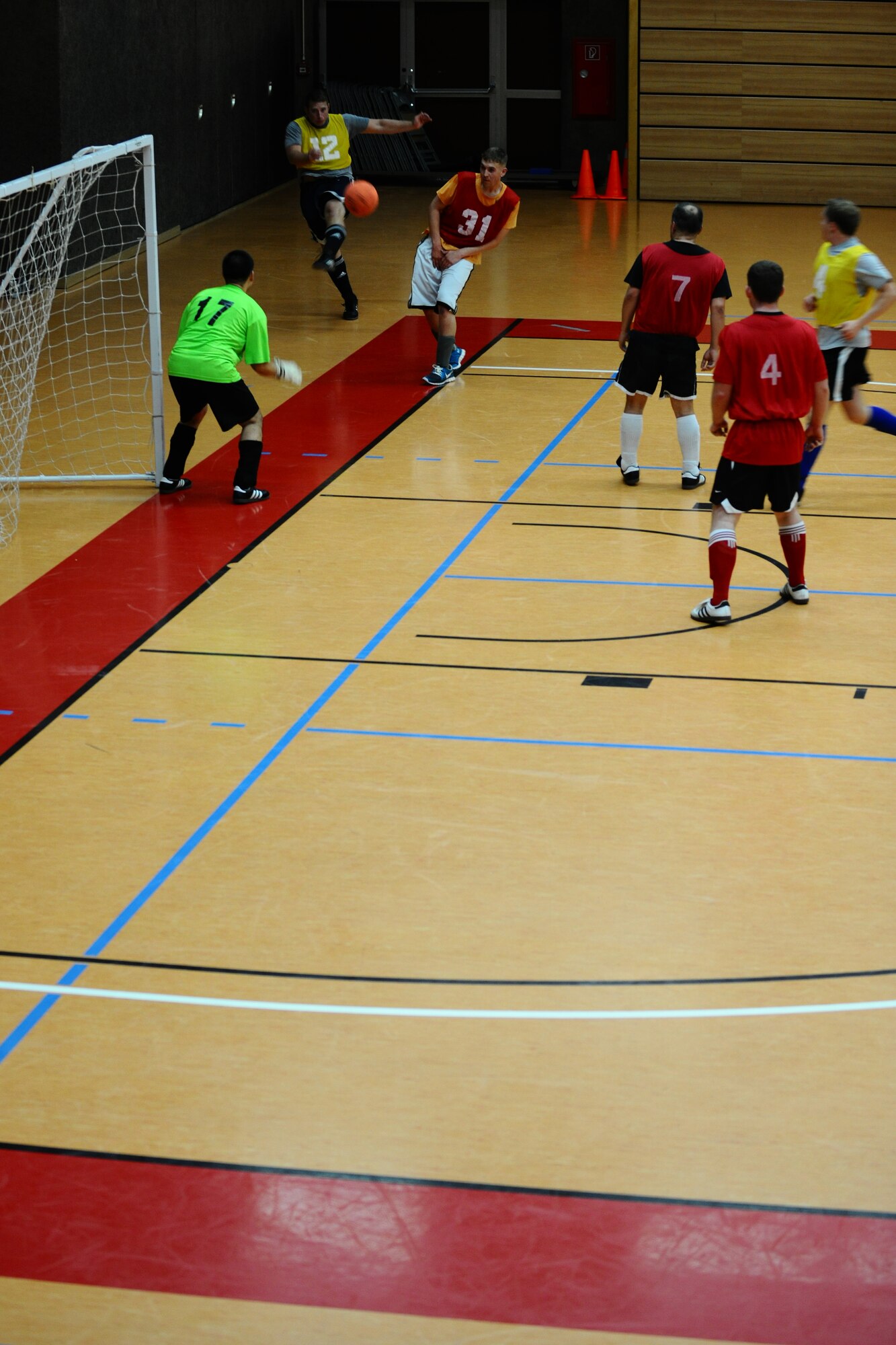 SPANGDAHLEM AIR BASE, Germany – Jarett Biggers, 81st Fighter Squadron, shoots the soccer ball during the indoor soccer championship at the Skelton Memorial Fitness Center here June 12. The 52nd Force Support Squadron defeated the 81st FS in the first game 7-6. The 81st FS won the double-elimination championship after winning the second game 9-5. (U.S. Air Force photo by Airman 1st Class Matthew B. Fredericks/Released)
