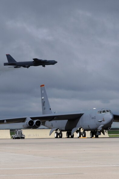 MINOT AIR FORCE BASE, N.D. -- A B-52H Stratofortress takes flight while a second Buff begins to power up its engines during a rapid launch that concluded the end of an exercise here June 11.The rapid launch was a successful conclusion to the exercise which tested Airmen's combat readiness and ability to deploy at a short notice at the request of combatant commanders. (U.S Air Force photo/Airman 1st Class Stephanie Ashley)