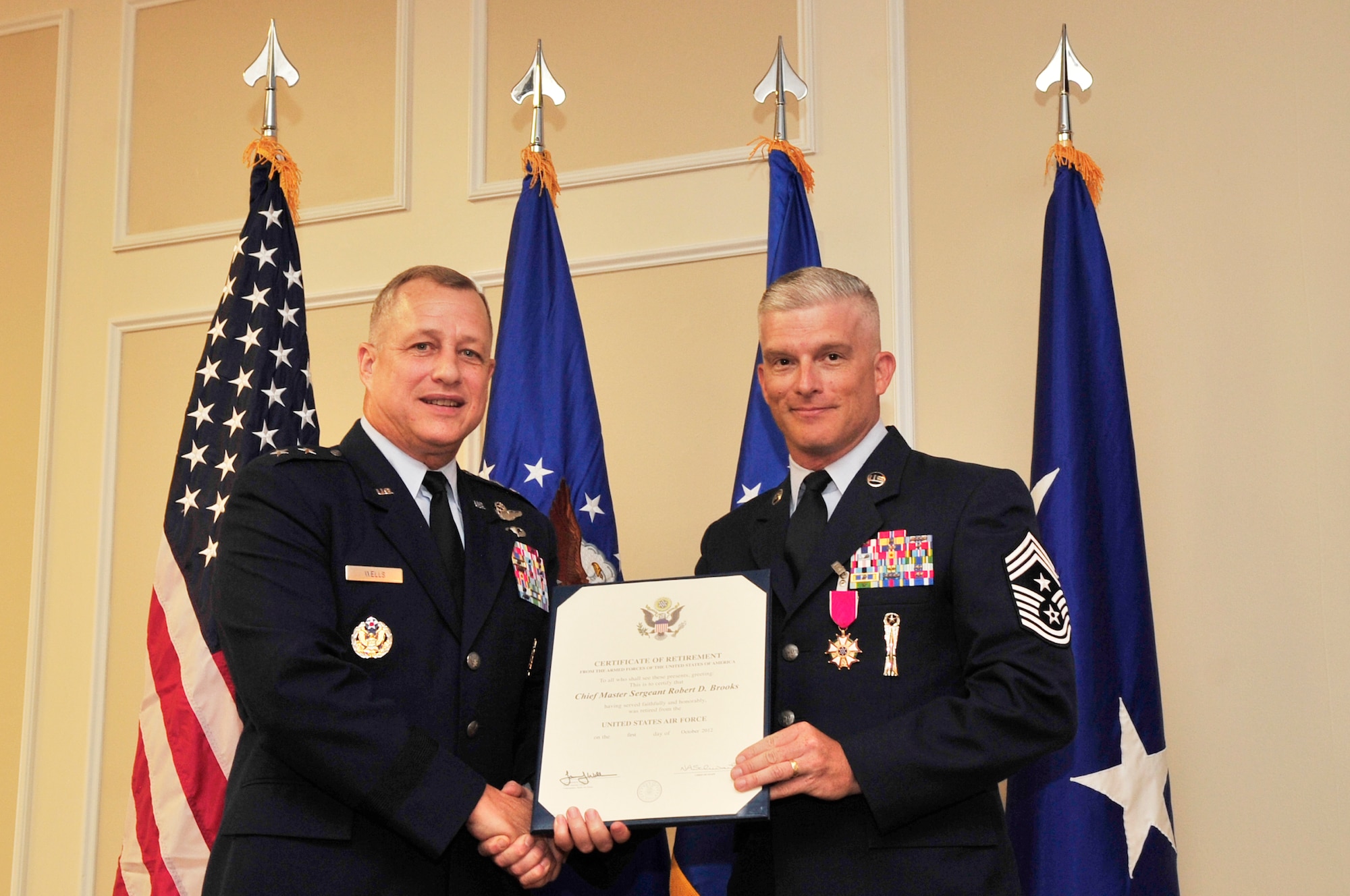 U.S. Air Force Chief Master Sgt. Robert Brooks, 9th Air Force command chief, receives his certificate of retirement from Maj. Gen. Lawrence Wells, 9th Air Force commander, at his retirement ceremony at Shaw Air Force Base, S.C., June 8, 2012.  Brooks has been in the Air Force since 1987.(U.S. Air Force photo by Airman Nicole Sikorski/Released)