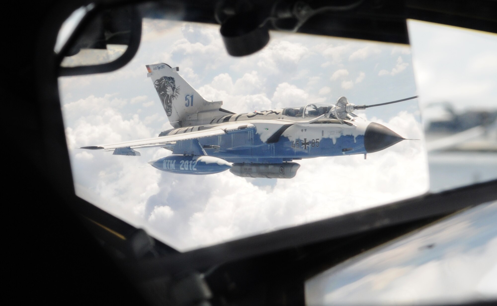 GERMANY – A reflection shows a German air force Tornado receiving fuel from a KC-135 Stratotanker assigned to the 100th Air Refueling Wing through a multipoint refueling system over German skies June 12, 2012. The aircraft was refueled as part of a training mission. (U.S. Air Force photo/Senior Airman Rachel Waller)