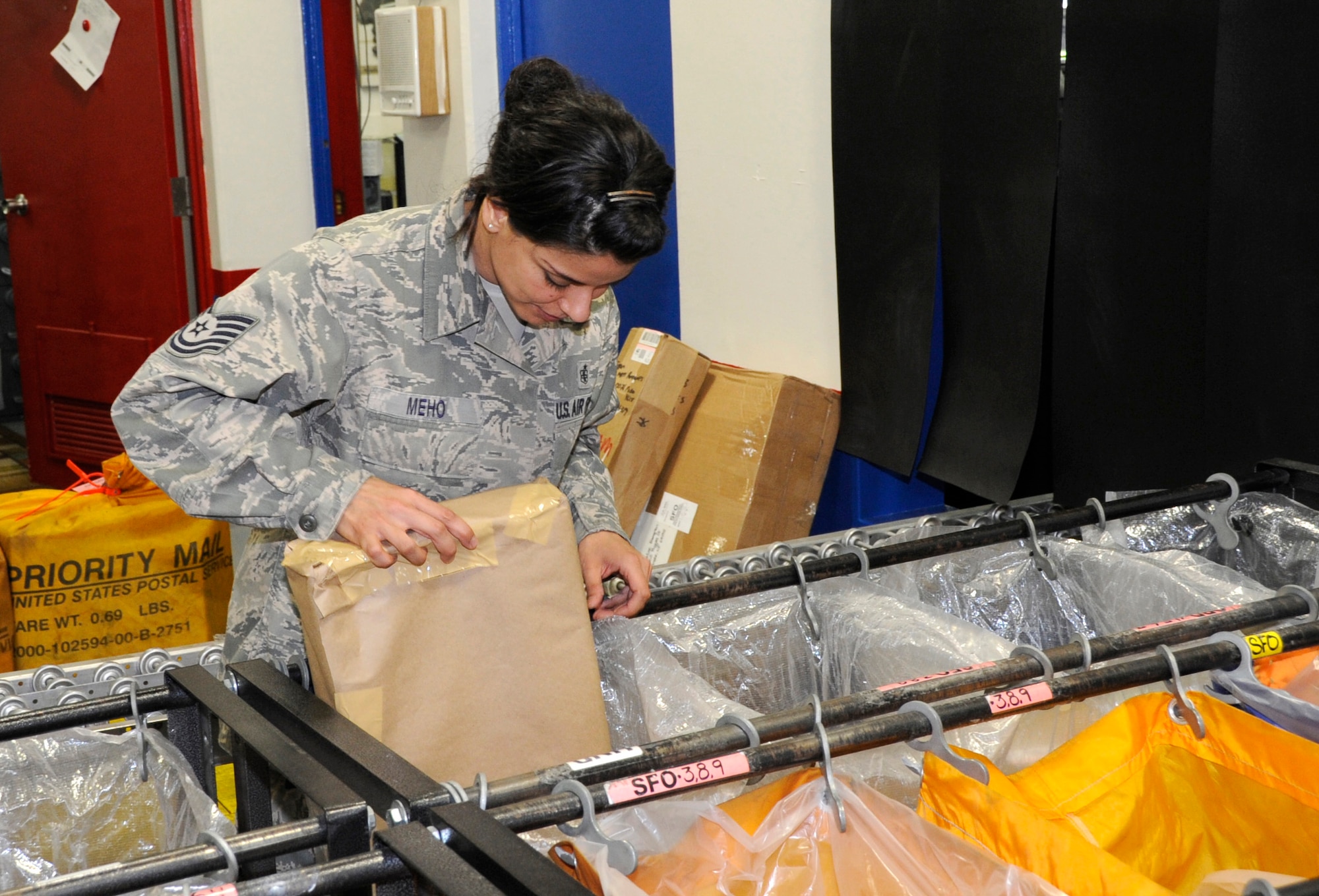 U.S. Air Force Tech Sgt. Dalylah Meho, 35th Communications Squadron custodian of postal effects, checks to make sure packages are bound for the correct destination at Misawa Air Base, Japan, June 6, 2012. The Misawa Air Base Post Office processes approximately 5,000 outgoing packages a week. For more information about the base post office call 226-3492. (U.S. Air Force photo by Airman 1st Class Kaleb Snay/Released)