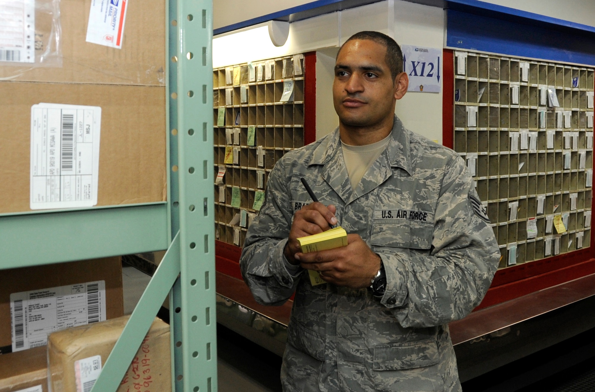 U.S. Air Force Staff Sgt. Aaron Bradley, 35th Communications Squadron postal clerk, documents incoming packages at Misawa Air Base, Japan, June 6, 2012. After documenting the information from the packages, the information is put into the correct post office box so the customer can quickly receive their parcel. For more information about the base post office call 226-3492. (U.S. Air Force photo by Airman 1st Class Kaleb Snay/Released)