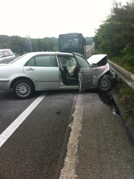 A Japanese driver’s car and a Misawa Air Base bus were moved to the side of the road in a major vehicle accident south of Sendai, Japan, June 7, 2012. Misawa Air Base servicemembers provided first-aid care to the injured driver. (Courtesy Photo/Released)