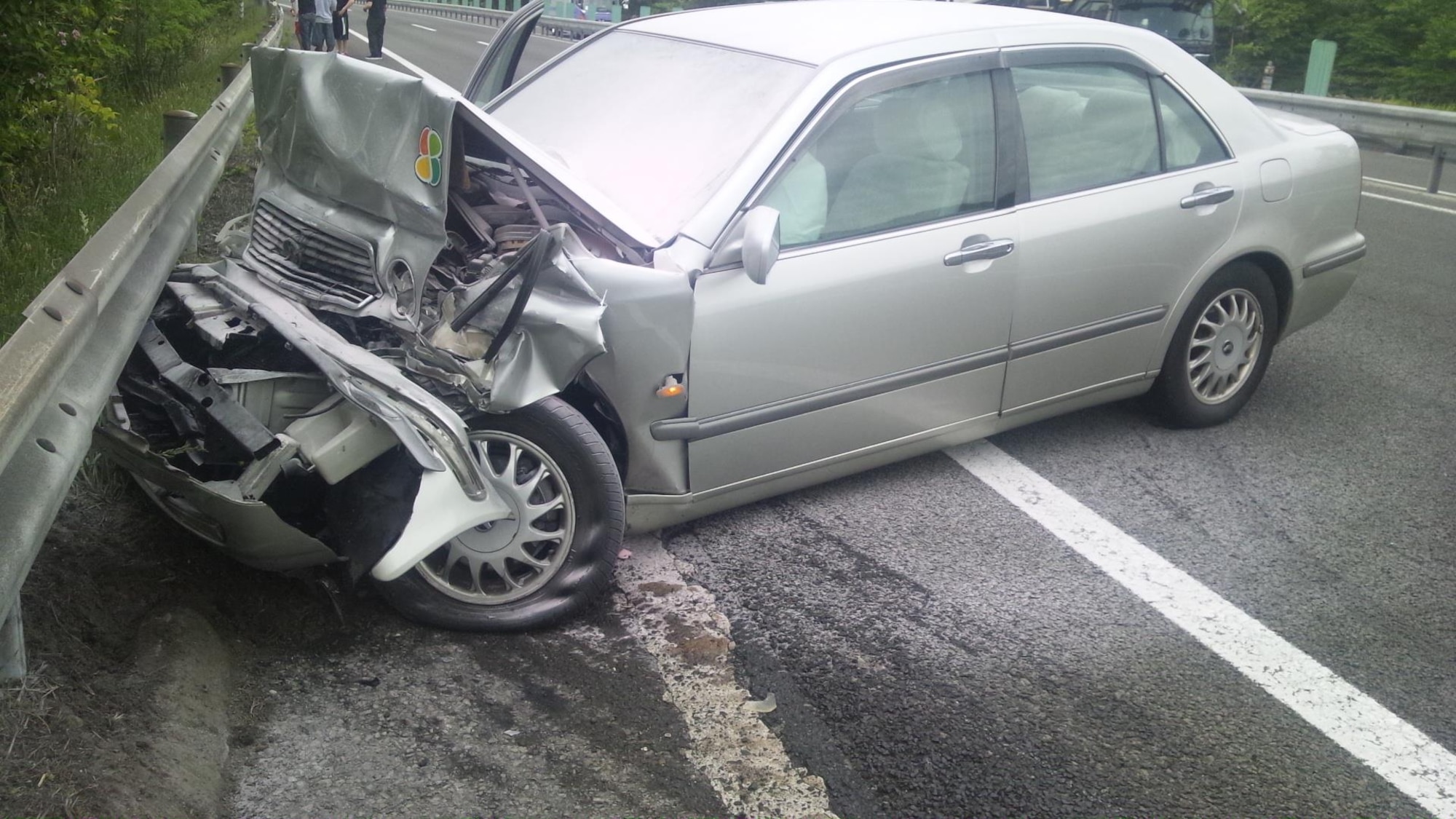 A Japanese national heavily impacted his car and a guardrail after hitting a Misawa Air Base bus in a major vehicle accident south of Sendai, Japan, June 7, 2012. The driver had minor injuries and a group of servicemembers provided first-aid care until local authorities could arrive. (Courtesy Photo/Released)