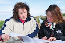 Walla Walla District Environmental Resource Specialist Jamie Hower and Portland District Project Manager Debra Henry review plans for a subdivision in Canyon County, Idaho, during a pre-construction compliance inspection in April 2011.
