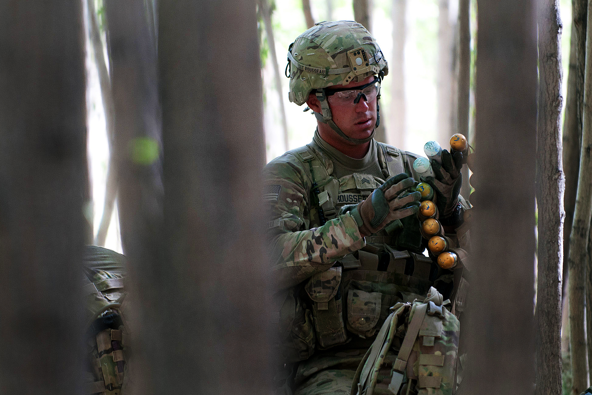 U.S. Army Sgt. Jacob Rousseau preps ammunition for an M320 grenade ...