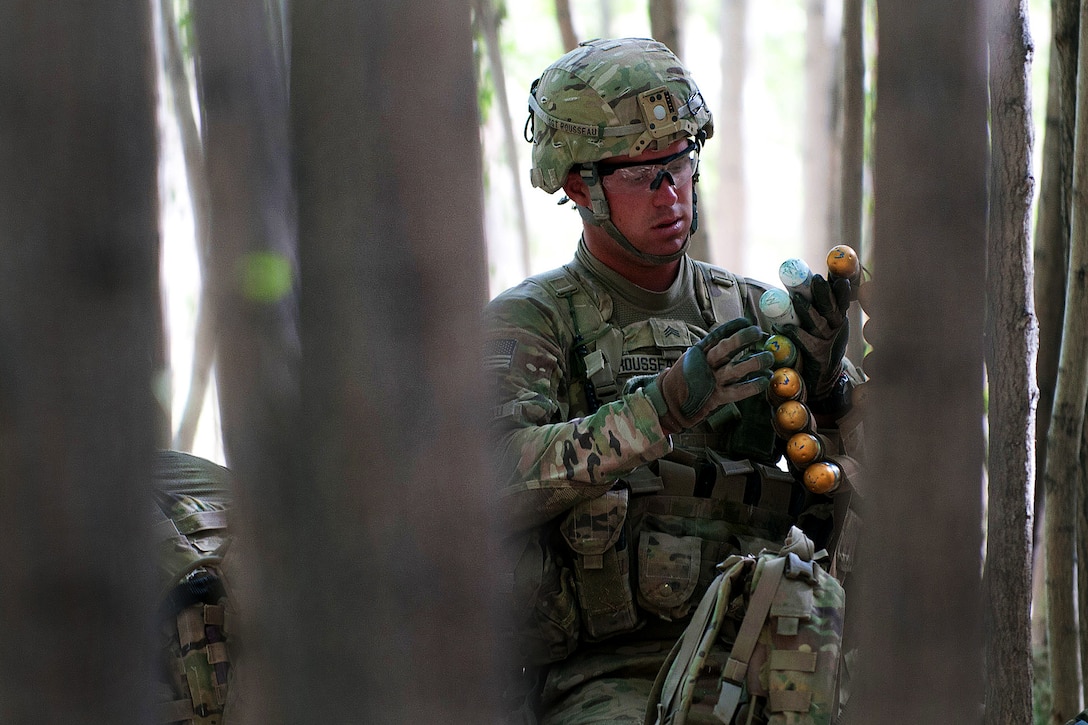 U.S. Army Sgt. Jacob Rousseau preps ammunition for an M320 grenade launcher during combat operations in Afghanistan's Ghazni province, June 4, 2012. Rousseau, a team leader, is assigned to the 82nd Airborne Division's 2nd Battalion, 504th Parachute Infantry Regiment, 1st Brigade Combat Team.