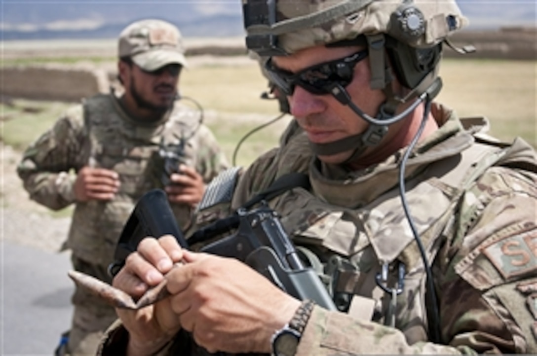 U.S. Air Force Tech. Sgt. Dale Spencer inspects an old round of ammunition that was found near a cave on a mountainside near Bagram Airfield, Parwan province, Afghanistan, on June 6, 2012.  Spencer is a squad leader with the 455th Air Expeditionary Wing, Task Force Reaper.  