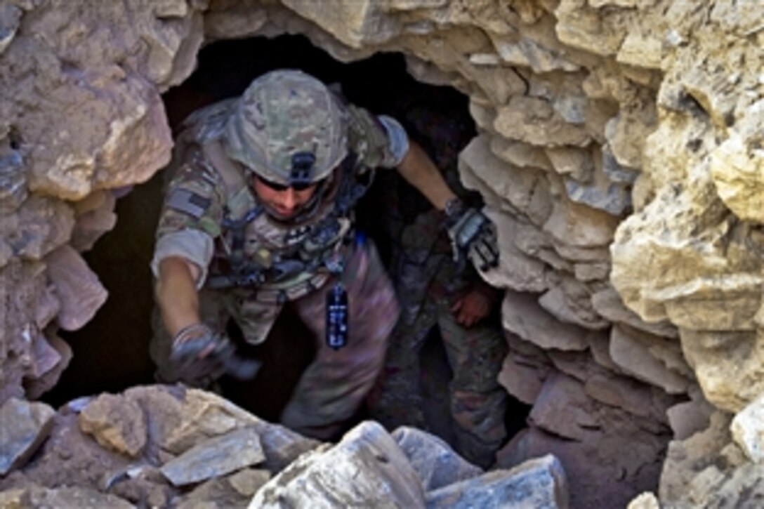 U.S. Air Force Senior Airman Edgar Cerrillo climbs out of a cave his unit was inspecting near Bagram Air Base in Afghanistan's Parwan province, June 6, 2012. Cerrillo, an advanced designated marksman, is assigned to the 455th Air Expeditionary Wing. The cave was part of an old Russian fighting position.