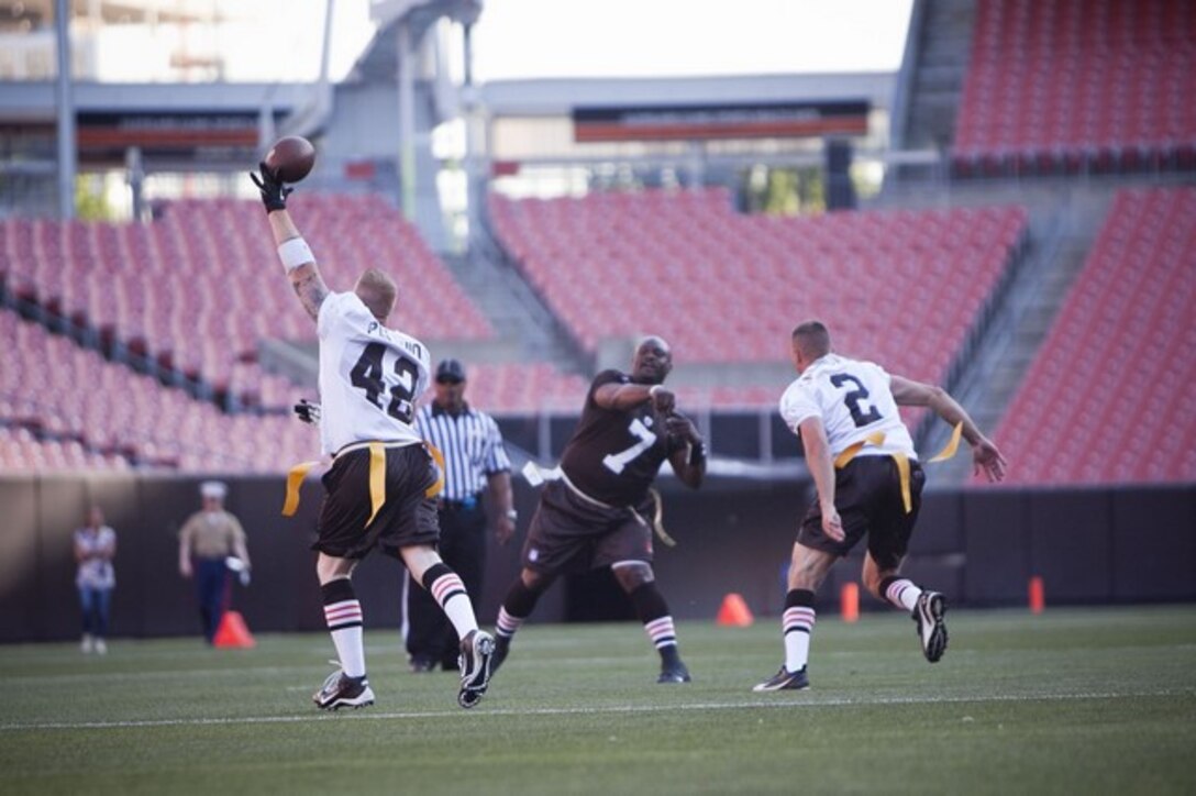 Staff Sgt. Thomas Pertronio, a member of the Marine Corps flag football team, blocks a pass during the Marine versus Cleveland First Responders game at the Cleveland Browns Stadium as part of Marine Week Cleveland June 13, 2012. A large crowd came out to support the friendly match-up, which is one of many events offered during Marine Week Cleveland. At half time, the Quantico Marine Corps Band performed several numbers and Marines re-enacted the flag raising on Iwo Jima. The first responders came out on top at the end of the game, beating the Marine Corps team 28-0. More than 750 Marines will be in Cleveland until June 17 displaying Marine aircraft, vehicles and equipment, as well as interacting and sharing with the public the values and character of the Marine Corps. One of the culminating events will be a Marine Air Ground Task Force demonstration, which showcases Marines' ability to assault from ship-to-shore via ground and air, June 16-17 at Burke Lakefront Airport.::r::::n::