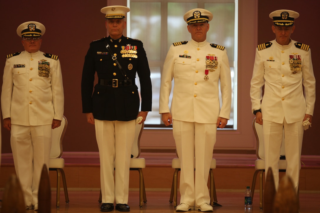 Cmdr. Steven R. Dundas, chaplain with Marine Corps Base Camp Lejeune, Lt. Gen. John M. Paxton, commanding general of II Marine Expeditionary Force, Capt. Daniel J. Zinder, former commanding officer of Naval Hospital Camp Lejeune and Capt. David A. Lane, new commanding officer of NHCL stand at attention and prepare to depart from NHCL’s Change of Command ceremony in accordance with Naval traditions aboard MACB Camp Lejeune June 8. Zinder relinquished command of NHCL to Lane after serving at the hospital for two years.