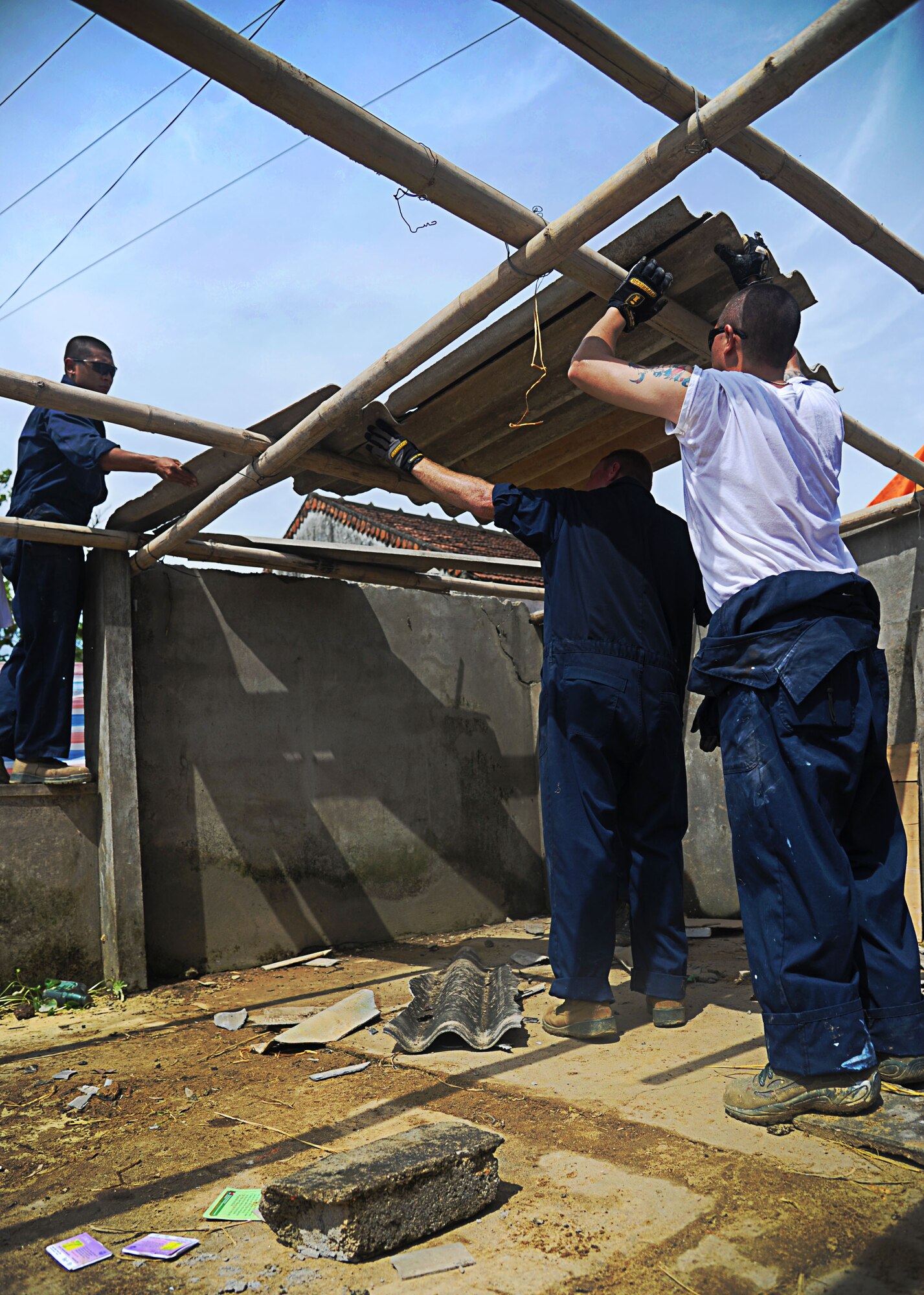 Airmen from the 647th Civil Engineering Squadron at Joint Base Pearl Harbor-Hickam, Hawaii, work to restore the Xuan Lam Medical Clinic during Pacific Angel-Vietnam 12 in Nghe An Province, Vietnam, June 12. The restoration project is part of an eight-day humanitarian assistance operation designed to help improve the lives of  Vietnamese in the province. Operation Pacific Angel gives the U.S. an opportunity to support the efforts of partner nations in the Pacific region by providing medical, dental, optometry and engineering assistance to the host nation citizens. (U.S. Air Force photo/Senior Airman Lauren Main) 