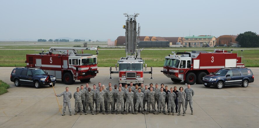The Kunsan Fire Department poses for a group shot after earning the 2011 Air Force Small Fire Department of the Year award, June 15, 2012, at Kunsan Air Base, Republic of Korea. They were judged in six major areas, including innovativeness, customer service and quality of life initiatives. (U.S. Air Force photo/Staff Sgt. Rasheen Douglas)