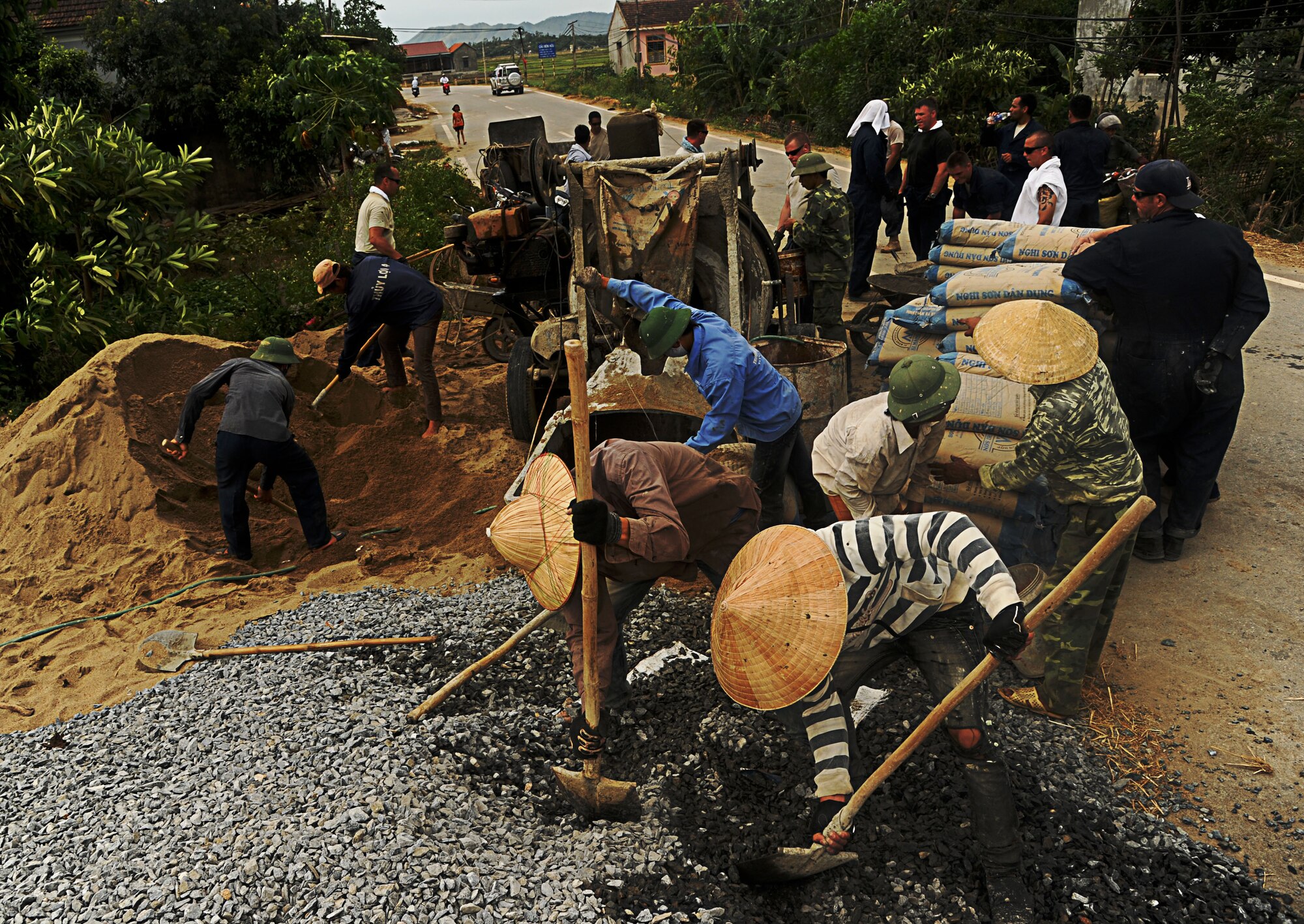 Vietnamese contractors work side-by-side with their U.S. Air Force counterparts to mix and lay cement, while restoring the Xuan Lam Medical Clinic in Nghe An Province, Vietnam, during Pacific Angel, June 14. The eight-day engagement includes health services outreach, as well as engineering programs and subject-matter expert exchanges between the U.S. and Vietnam. Operation Pacific Angel gives the U.S. an opportunity to support the efforts of partner nations in the Pacific region by providing medical, dental, optometry and engineering assistance to the host nation citizens. (U.S. Air Force photo/Senior Airman Lauren Main) 