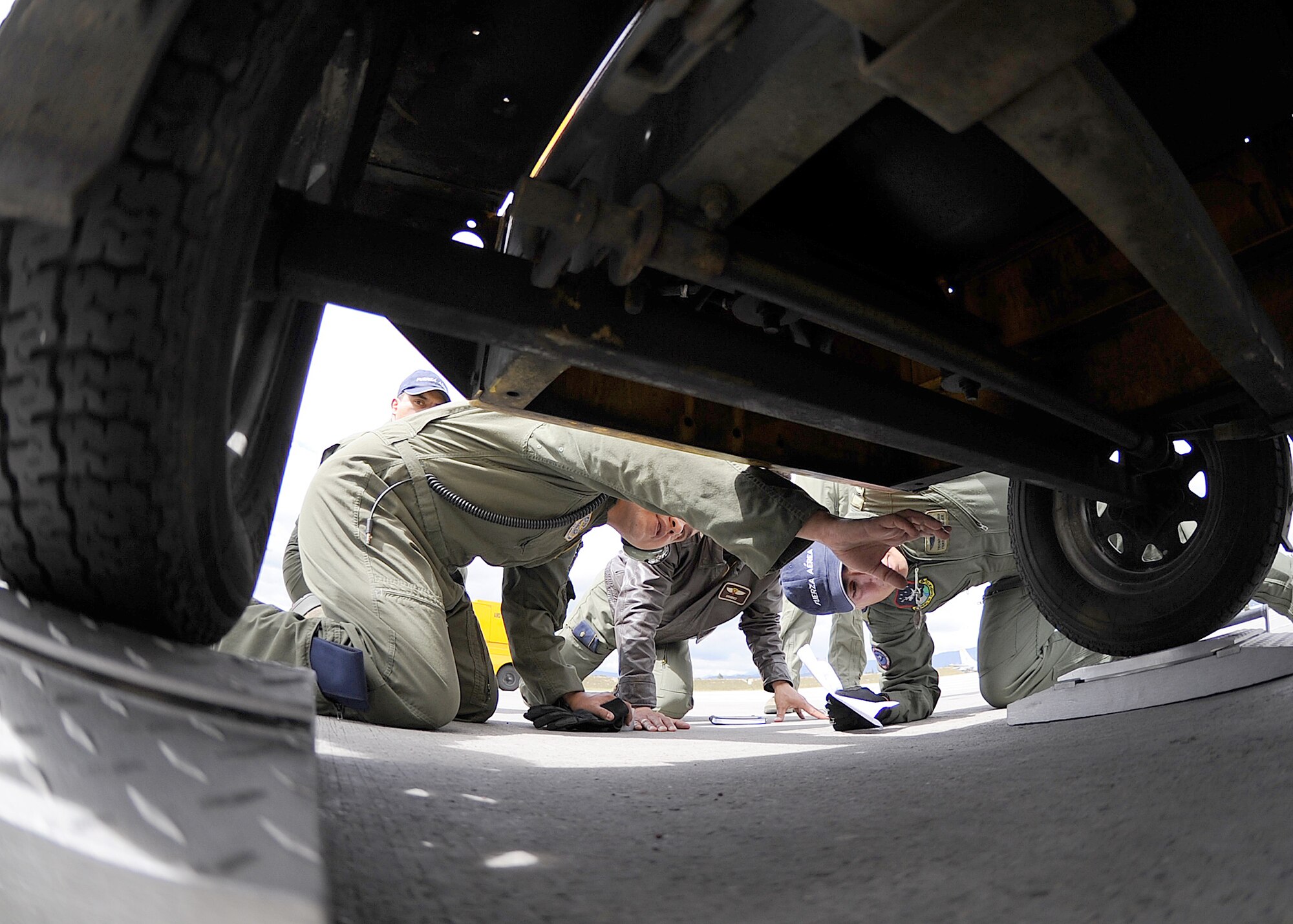 Staff Sgt. Jorge Borges, 571st Mobility Support Advisory Squadron loadmaster, shows tie-down locations on rolling stock during the pallet build-up seminar June 6 at Commando Aéreo de Transporte Militar, Bogota, Colombia.  (U.S. Air Force photo by Tech. Sgt. Lesley Waters)