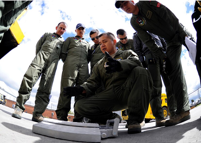 Staff Sgt. Jorge Borges, 571st Mobility Support Advisory Squadron loadmaster air advisor, explains how the portable scales work during the pallet build-up seminar June 6, 2012, at Commando Aéreo de Transporte Militar, Bogota, Colombia. (U.S. Air Force photo/Tech. Sgt. Lesley Waters)