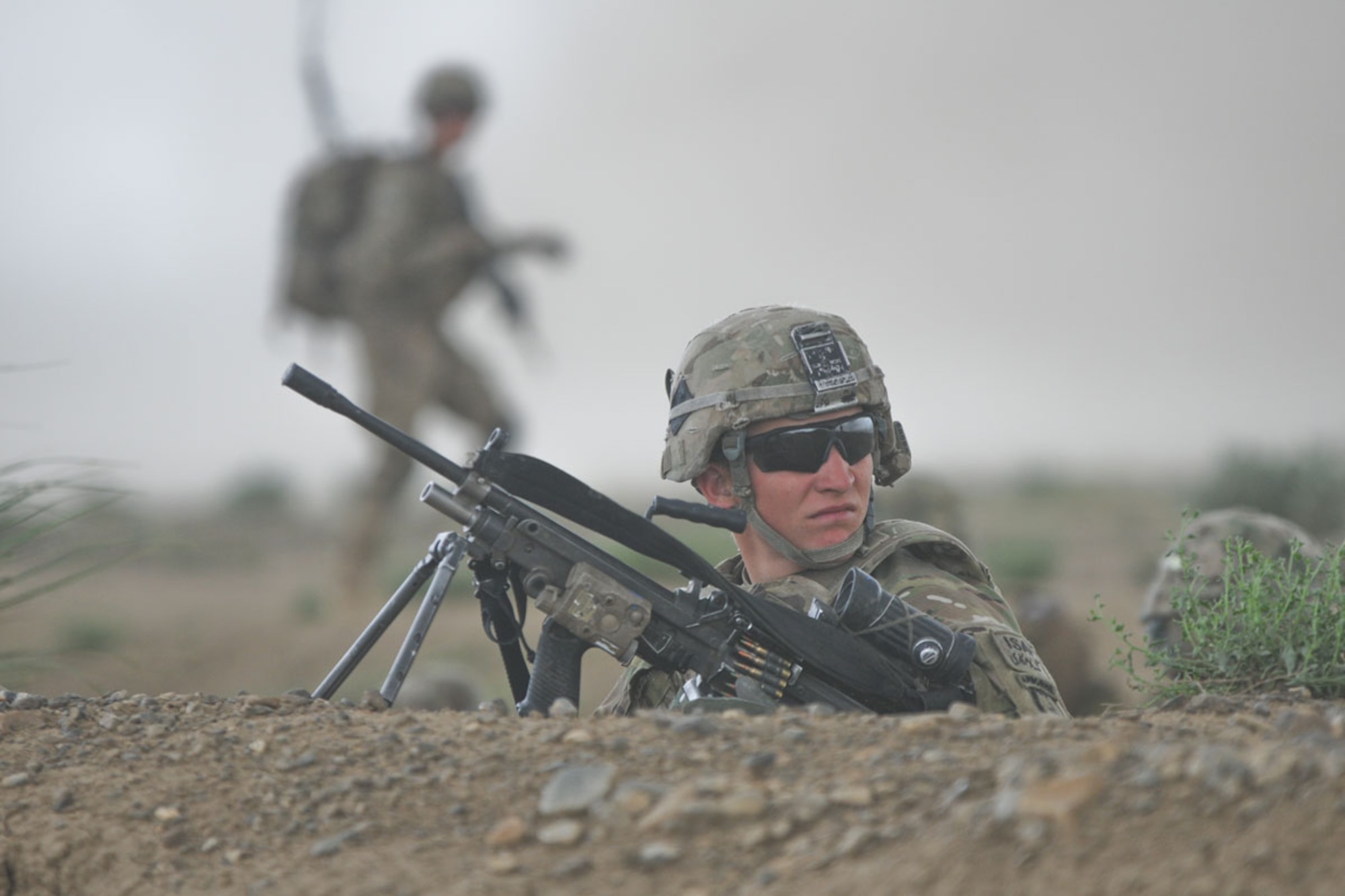 Pfc. Michael McCroskey, a native of Liberal, Kan., and M249 gunner assigned to
Blackfoot Company, 1st Battalion (Airborne), 501st Infantry Regiment, scans his sector while providing security in Terezayi district June 1 to support a post-blast analysis hours after an improvised explosive device exploded. (U.S. Army photo/Staff Sgt. Jason Epperson)