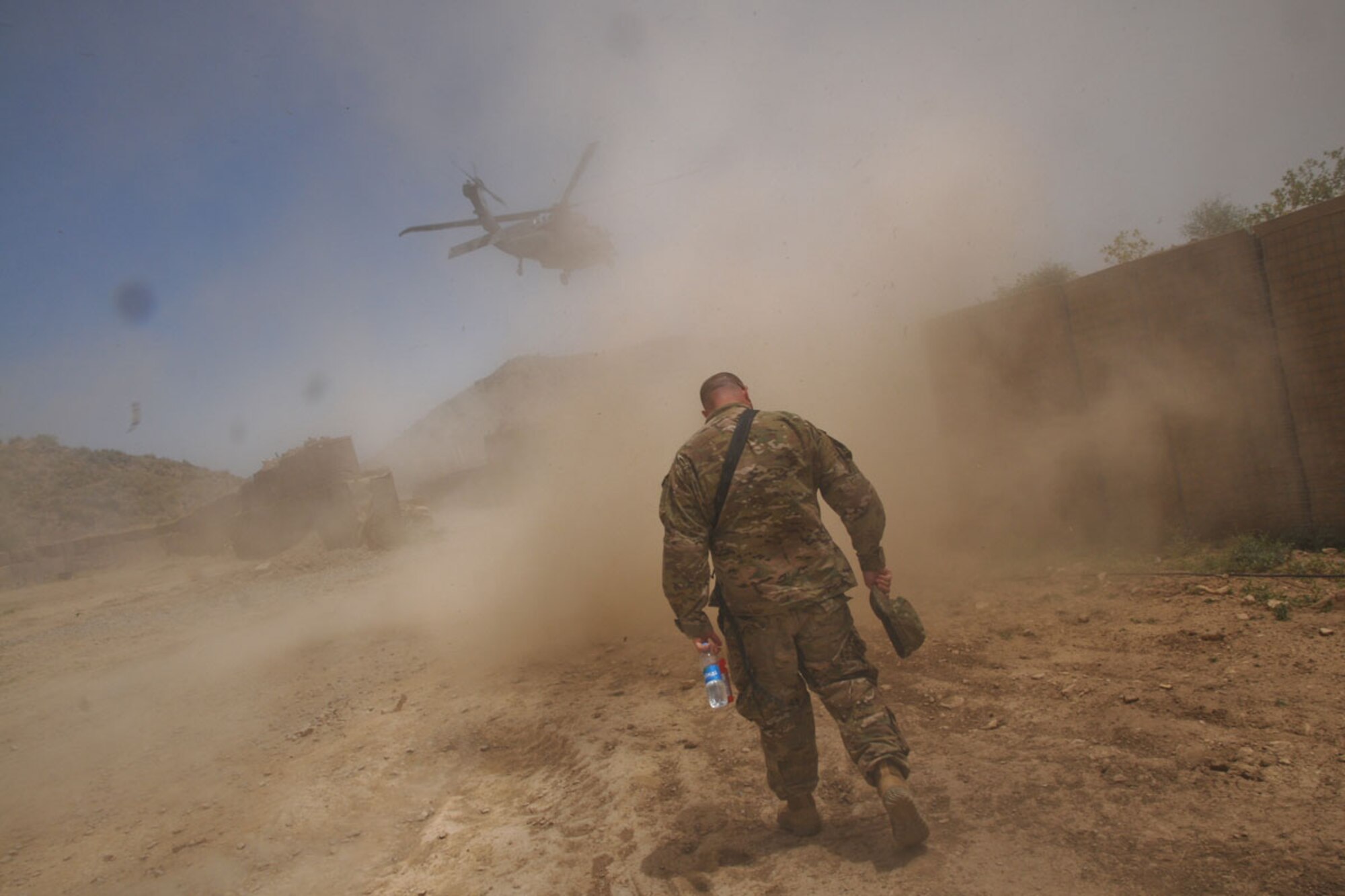 Bordelon watches as a UH-60 fl ies over Combat Outpost Chergataw June 1. (U.S. Army photo/Staff Sgt. Jason Epperson)