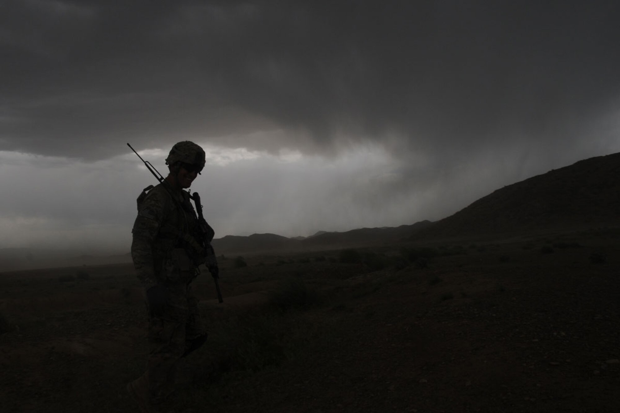 Army Staff Sgt. Chad Bordelon, a native of Lafayette, La., and squad leader assigned to B/1-501st Inf., tactically relocates his position as a storm moves in. (U.S. Army photo/Staff Sgt. Jason Epperson)