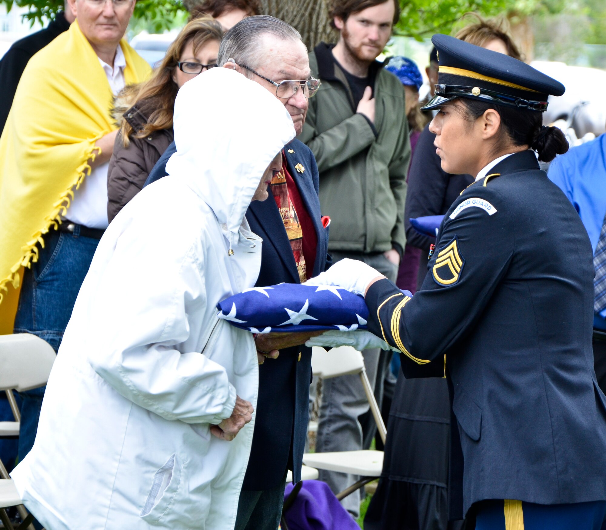 Tommie and Wilma Tindell accept a flag honoring their friends who were among the 87 “Forgotten Heroes” of a tragic 1952 Air Force C-124A Globemaster crash during a memorial dedication ceremony at the Grant County International Airport in Moses Lake, Wash., June 9, 2012. Tommie Tindell would have been among the ‘Forgotten’ had his wife not convinced him to switch seats for a later flight with his best friend. The personnel transport took off Dec. 20, 1952, from what was then Larson Air Force Base as part of a continuation trip from Korea called “Operation Sleighride,” bringing servicemembers home for the holidays. (U.S. Air Force photo by Senior Airman Benjamin Stratton/Released)