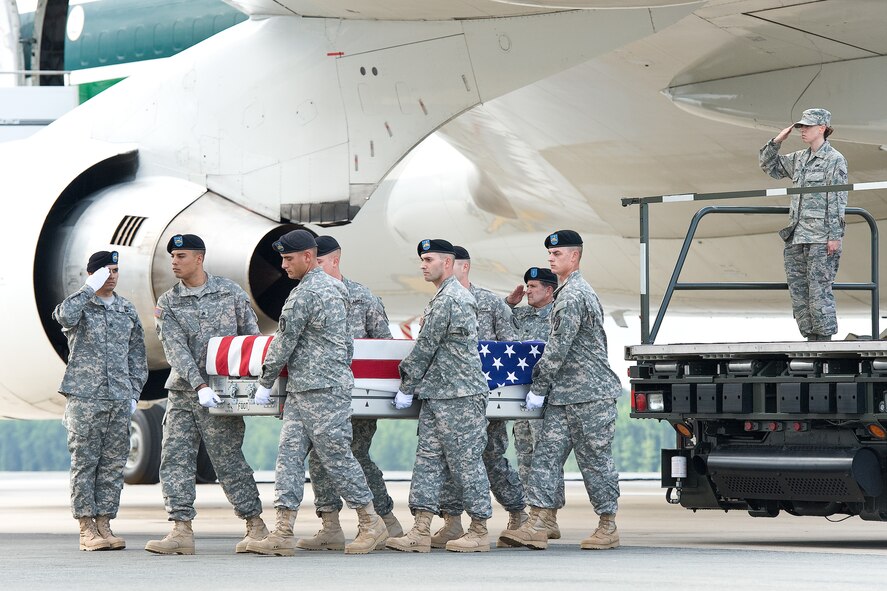 A U.S. Army carry team transfers the remains of Army Spc. Trevor A. Pinnick, of Lawrenceville, Ill., at Dover Air Force Base, Del., June 14, 2012. Pinnick was assigned to the 18th Engineer Company, 3rd Stryker Brigade Combat Team, 2nd Infantry Division, Joint Base Lewis-McChord, Wash. (U.S. Air Force photo/Roland Balik)
