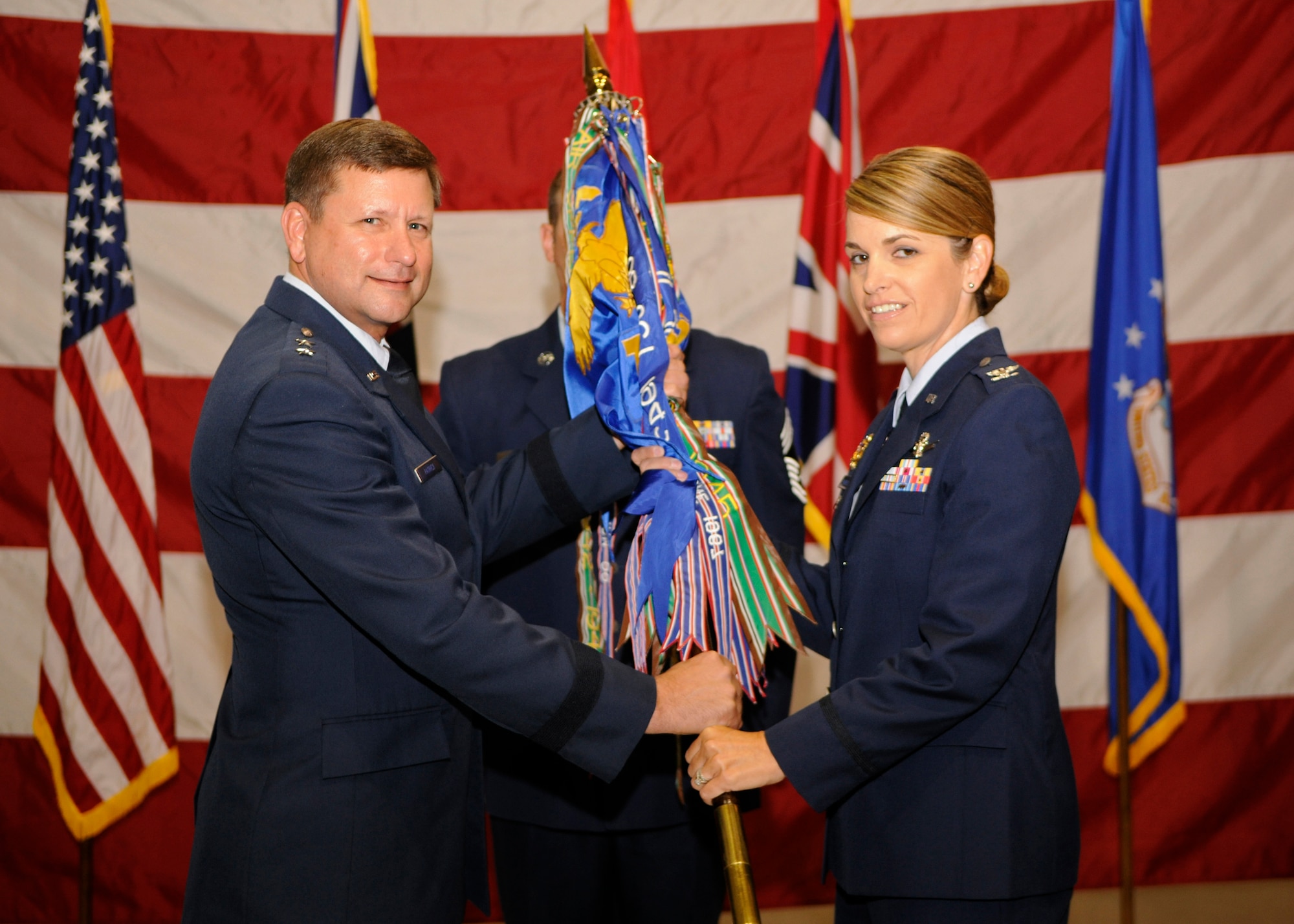 VANDENBERG AIR FORCE BASE, Calif. -- Maj Gen. Leonard Patrick, 2nd Air Force commander, passes the official guidon to Col. Michele Edmondson, placing her in command of the 381st Training Group here June 13, 2012. Edmondson comes to the 381st TRG from a division of the Joint Staff in the Pentagon, where she provided strategic guidance on joint C4 satellite, spectrum, aerial and terrestrial transport systems and programs. (U.S. Air Force photo/Michael Peterson)