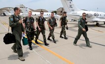 Capt. Dave Gagnon, 86th Flying Training Squadron, and 1st Lt. Sean Domincovitch, 86th FTS, walk a group of Civil Air Patrol cadets to a waiting T-1A Jayhawk for a flight during a CAP summer program at Laughlin Air Force Base, Texas, June 12, 2012. The CAP cadets are spending a week at Laughlin in a training program designed to show the cadets what Specialized Undergraduate Pilot Training is like. (U.S. Air Force photo/Airman 1st Class Nathan Maysonet)