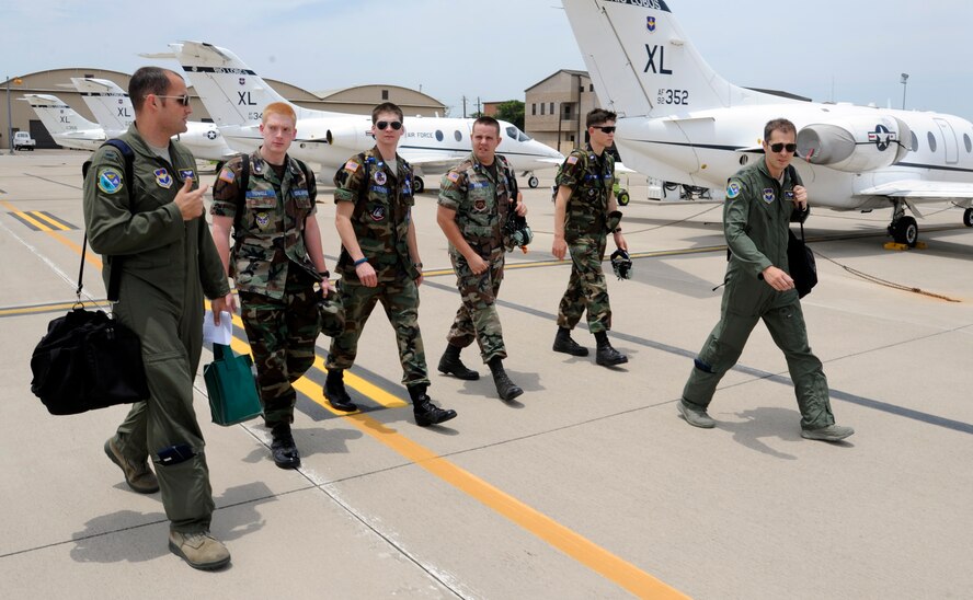 Capt. Dave Gagnon, 86th Flying Training Squadron, and 1st Lt. Sean Domincovitch, 86th FTS, walk a group of Civil Air Patrol cadets to a waiting T-1A Jayhawk for a flight during a CAP summer program at Laughlin Air Force Base, Texas, June 12, 2012. The CAP cadets are spending a week at Laughlin in a training program designed to show the cadets what Specialized Undergraduate Pilot Training is like. (U.S. Air Force photo/Airman 1st Class Nathan Maysonet)