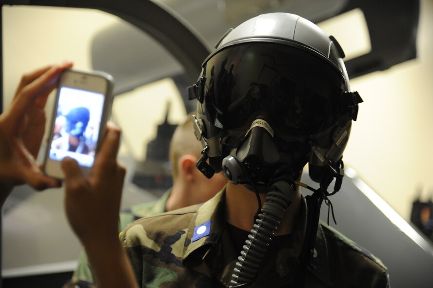 A cadet in the Civil Air Patrol gets his picture taken by a fellow student after trying on a flight helmet at aerospace physiology during a CAP summer program at Laughlin Air Force Base, Texas, June 12, 2012. The CAP cadets are spending a week at Laughlin in a training program designed to show the cadets what Specialized Undergraduate Pilot Training is like. (U.S. Air Force photo/Airman 1st Class Nathan Maysonet)