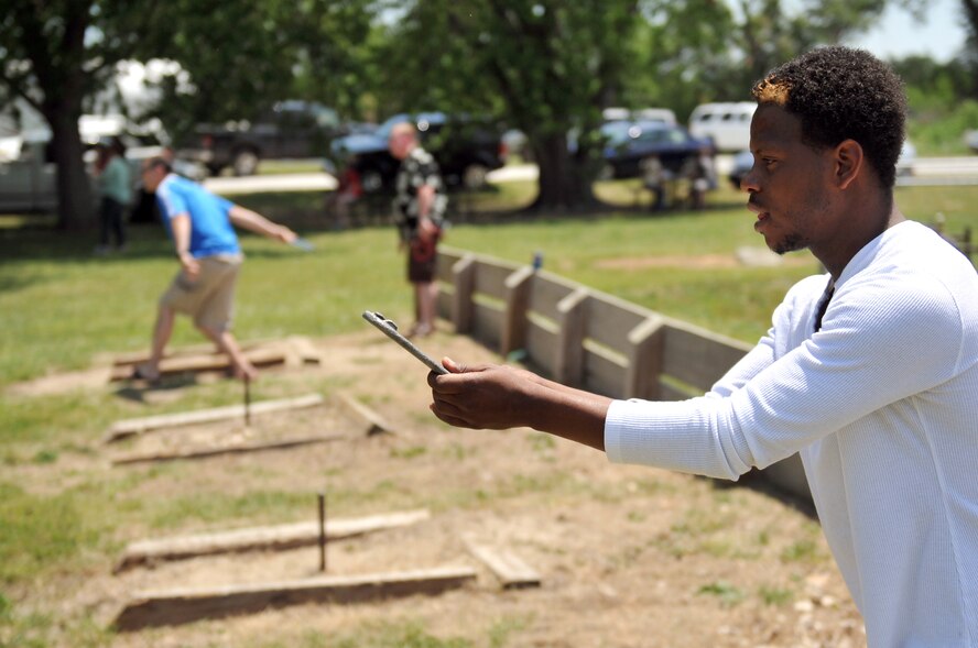 Ryan Ross from Bellevue, Neb., takes aim during a game of horseshoes at the Offutt Advisory Council's annual Offutt Appreciation Day Picnic at the Offutt Air Force Base Lake June 8. This was the 19th annual picnic sponsored by the OAC.  (U.S. Air Force photo by Jeff W. Gates/Released)