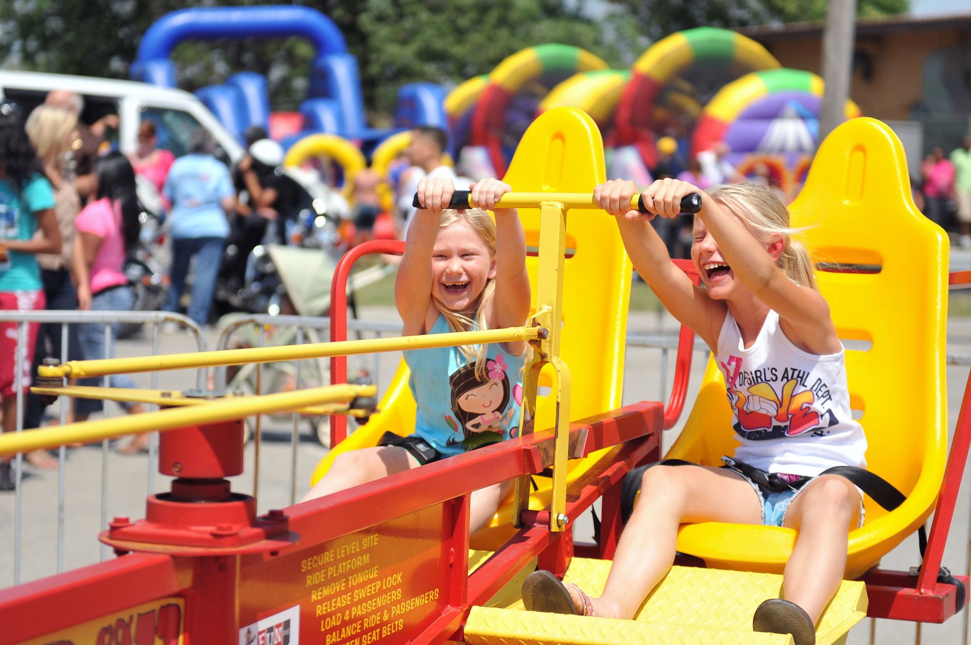 Ann and Abbey Wilson, daughters of Senior Master Sgt. Dennis Wilson, hold on while enjoying the G-Force ride at the Offutt Advisory Council's annual Offutt Appreciation Day Picnic at the Offutt Air Force Base Lake June 8. Team Offutt?s Soldiers, Sailors, Airmen, Marines, civilians and their families enjoyed free food, and entertainment from the band ?Out of the Fire.? (U.S. Air Force photo by Jeff W. Gates/Released)