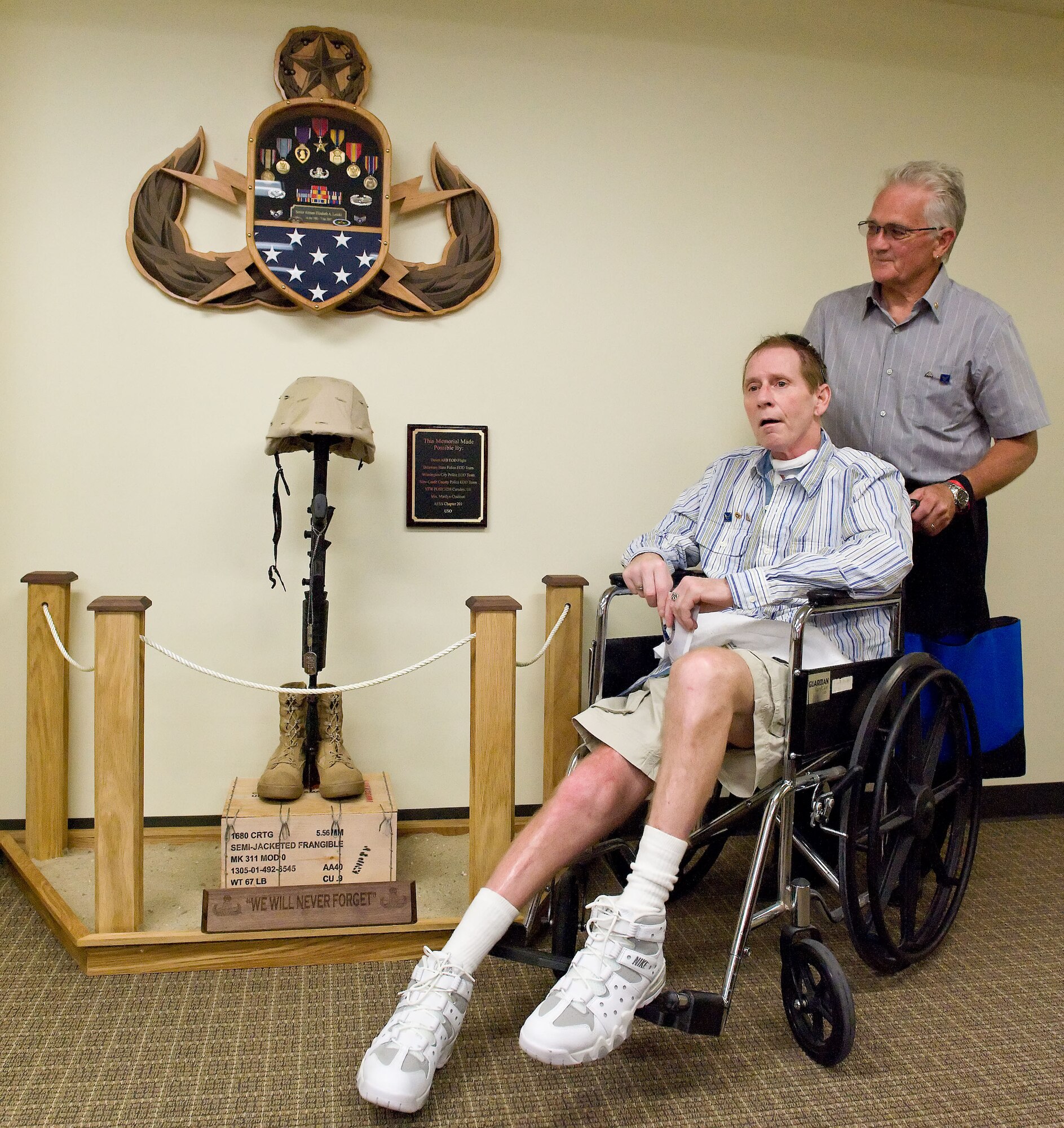 Left, Stephen Loncki, father of the late Senior Airman Elizabeth Loncki, and Walter Loncki, her grandfather, rest beside a memorial display dedicated to Senior Airman Elizabeth Loncki June 13, 2012, at the First Term Airman's Center on Dover Air Force Base, Del. Classroom 315 at FTAC was dedicated to Loncki, an explosive ordinance disposal technician with the 775th Civil Engineer Squadron, Hill AFB, Utah. (U.S. Air Force photo by Roland Balik)