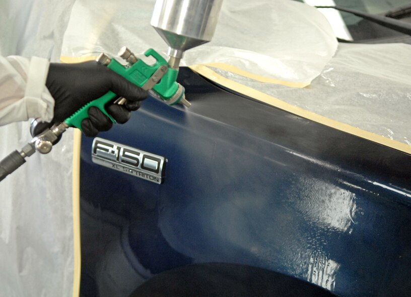 Tech. Sgt. Thomas Reistroffer, 2nd Logistics Readiness Squadron Vehicle Maintenance Flight Allied Trade Center body shop, sprays clear coat finish on a government vehicle's front fender at Barksdale Air Force Base, La., June 12. The VMF maintains and services more than 700 vehicles at this facility. (U.S. Air Force photo/Staff Sgt. Jason McCasland)(RELEASED)