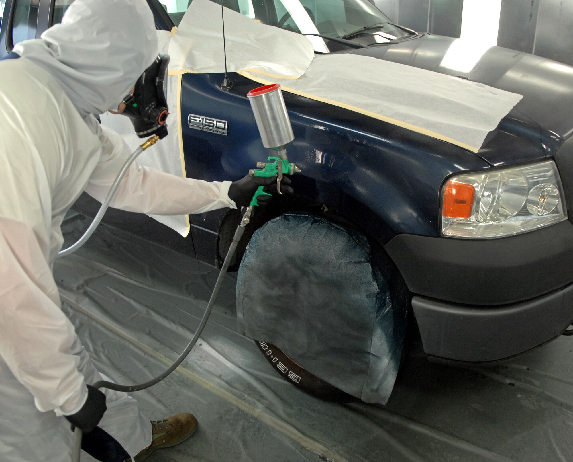 Tech. Sgt. Thomas Reistroffer, 2nd Logistics Readiness Squadron Vehicle Maintenance Flight Allied Trade Center body shop, sprays clear coat finish on a government vehicle's front fender at Barksdale Air Force Base, La., June 12. The body shop helps to keep a vehicle fleet worth more than $57 million up to standards. (U.S. Air Force photo/Staff Sgt. Jason McCasland)(RELEASED)