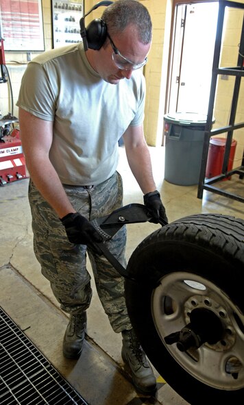 Tech. Sgt. Vincent St. Hilaire, 2nd Logistics Readiness Squadron Vehicle Maintenance Flight Allied Trade Center tire shop, checks the rim measurement after installing a new tire at Barksdale Air Force Base, La., June 12. By changing government vehicles tires' on base, the tire shop saves the wing more than $20,000 a year. (U.S. Air Force photo/Staff Sgt. Jason McCasland)(RELEASED)