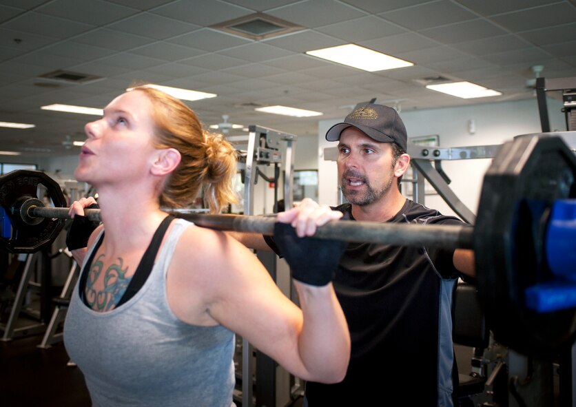 Chris Andruschkevich, Aerobics and Fitness Association of America certified personal trainer, encourages U.S. Air Force Staff Sgt. Jessica Carter, 23d Equipment Maintenance Squadron precision guided munitions crew chief, during a training session at the Freedom I Fitness Center at Moody Air Force Base, Ga., June 13, 2012. Andruschkevich specializes in helping Airmen improve their Air Force physical fitness assessment scores. (U.S. Air Force photo by Airman 1st Class Jarrod Grammel/Released)
