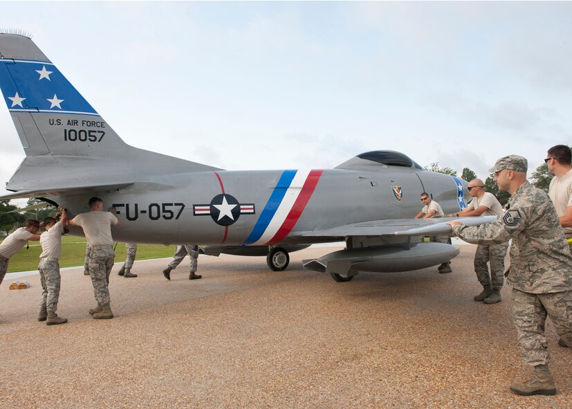 Moody Airmen work together to push an F-86L Sabre into position at the President George W. Bush Air Park at Moody Field June 12, 2012, at Moody Air Force Base, Ga. The F-86 was brought to the base April 25 and has since undergone extensive restoration to preserve a piece of U.S. Air Force history. (U.S. Air Force photo by Senior Airman Eileen Meier/Released)