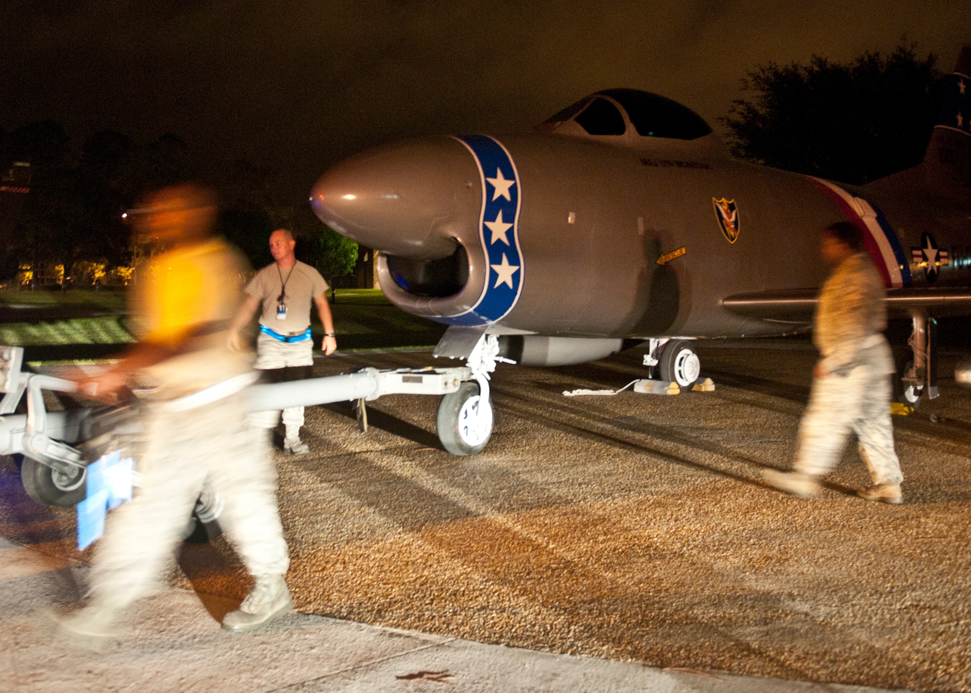 Moody Airmen work quickly to position a newly refurbished F-86L Sabre onto its display at the President George W. Bush Air Park at Moody Field in the early morning of June 12, 2012, at Moody Air Force Base, Ga. The historic aircraft arrived on a flat-bed truck April 25 from downtown Valdosta where it was known as a famous landmark that commemorated the late U.S. Air Force Maj. Lyn McIntosh and the heritage of the Flying Tigers. A re-dedication ceremony will be held with the McIntosh family present, forever placing the aircraft with other pieces of history at the air park. McIntosh, a Valdosta native, was one of five Airmen who died April 25, 1980, during Operation Eagle Claw, a mission ordered by President Jimmy Carter to rescue 52 Americans held captive in Iran. (U.S. Air Force photo by Senior Airman Eileen Meier/Released)