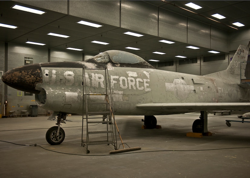 The paint on an F-86L Sabre is sanded off for primer to be applied during the refurbishment of the historic aircraft at the 23d Equipment Maintenance Squadron, fabrication flight hangar at Moody Air Force Base, Ga., June 6, 2012. With the help of several city and base agencies, the plane was relocated from downtown Valdosta to be restored and re-commemorated to the late U.S. Air Force Maj. Lyn McIntosh and the Flying Tigers heritage. McIntosh was born in Valdosta on October 11, 1946, and enlisted in the Air Force in 1969. He died April 25, 1980, during Operation Eagle Claw on a mission to rescue 52 Americans held captive in Iran. (U.S. Air Force photo by Senior Airman Eileen Meier/Released) 