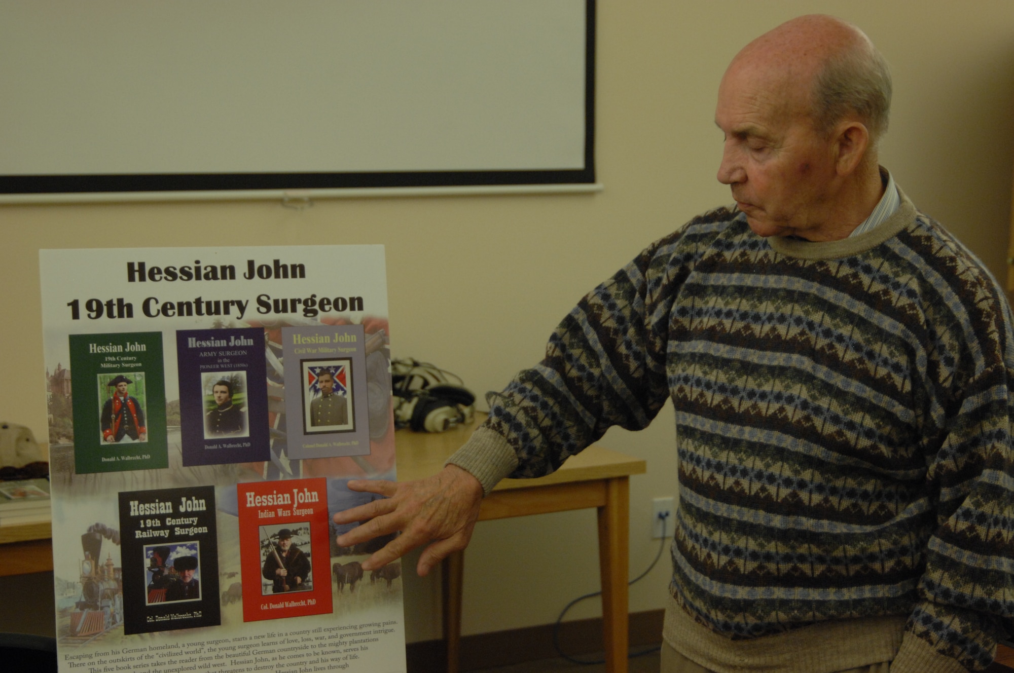 Dr. Donald Walbrecht, U.S. Air Force Col. (ret.), explains his book series entitled, “Hessian John 19th Century Surgeon,” at a book reading June 12, inside the library at Mountain Home Air Force Base, Idaho. Walbrecht was the 11th pilot to fly the Mach-3 SR-71 reconnaissance aircraft throughout his 30-year career. (U.S. Air Force photo/Senior Airman Benjamin Sutton) 