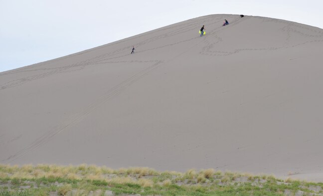 A family climbs a sand dune at Bruneau Dunes State Park, Idaho, June 7, 2012. The state park includes desert, dune, prairie, lake and marsh habitat. Some popular activities include fishing, bird watching, camping, hiking, swimming and viewing the stars at one of only two public observatories in Idaho. (U.S. Air Force photo/Airman 1st Class Heather Hayward)